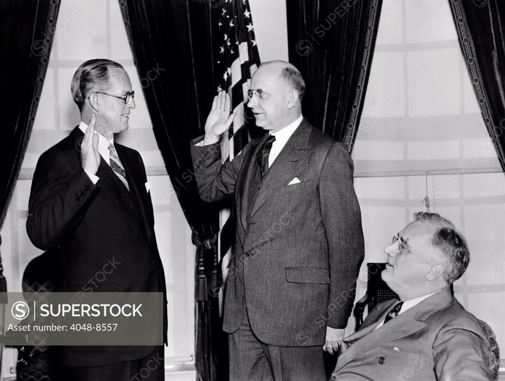 Joseph P. Kennedy takes the oath as U.S. Ambassador to the Court of St. James (Britain) with Supreme Court Justice STanley Reed in front of President Roosevelt. 2/18/1938. Courtesy: