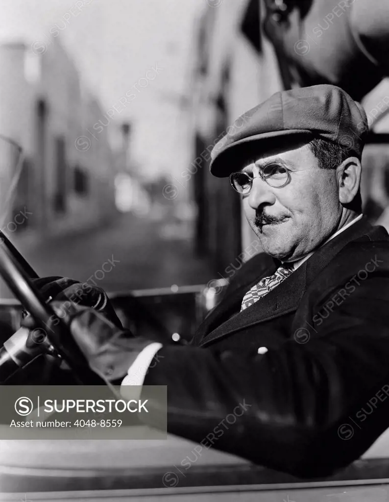 Portrait of man in drivers seat of car (All persons depicted are not longer living and no estate exists. Supplier warranties that there will be no model releease) Courtesy Everett Collection (Sev003592)