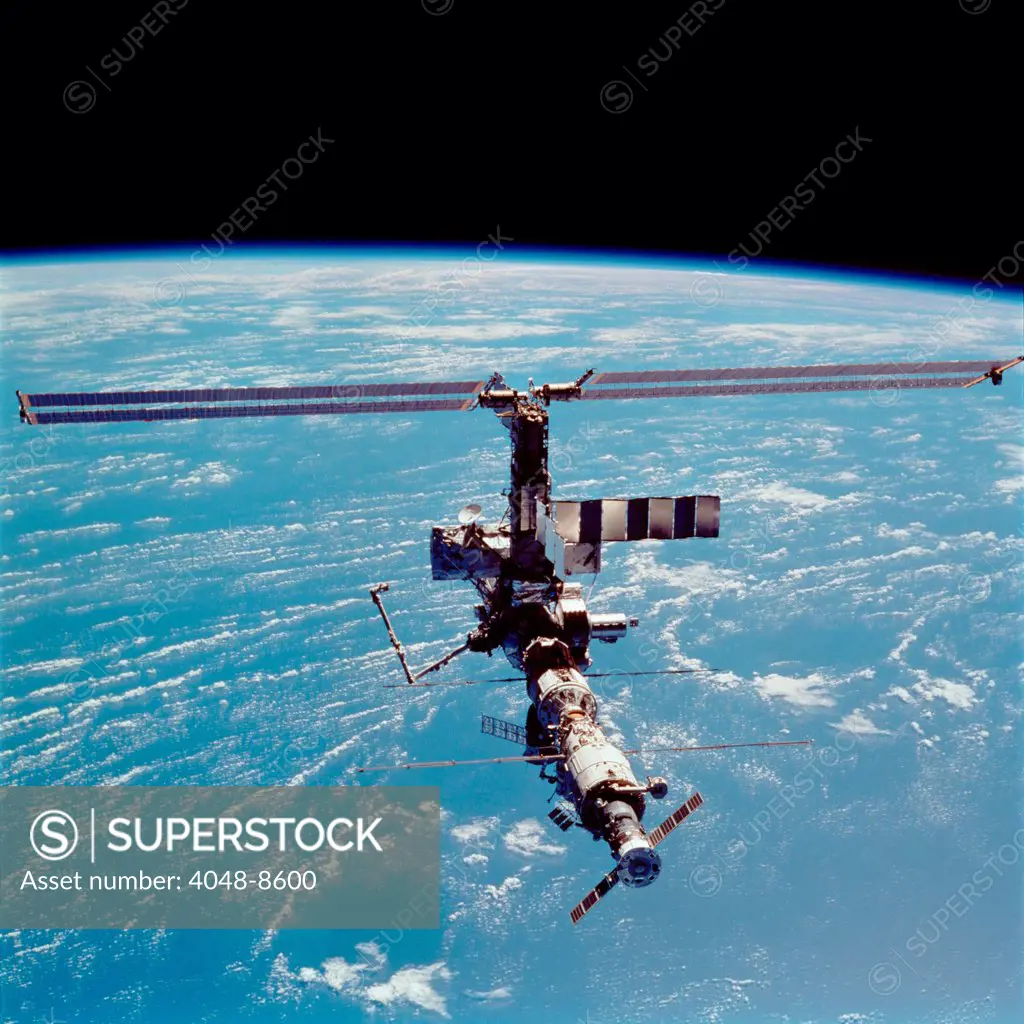 International Space Station in 2002. View of the expanding structure with added modules, solar panels, robotic cranes and a docked Soyuz space craft. April 17, 2002.