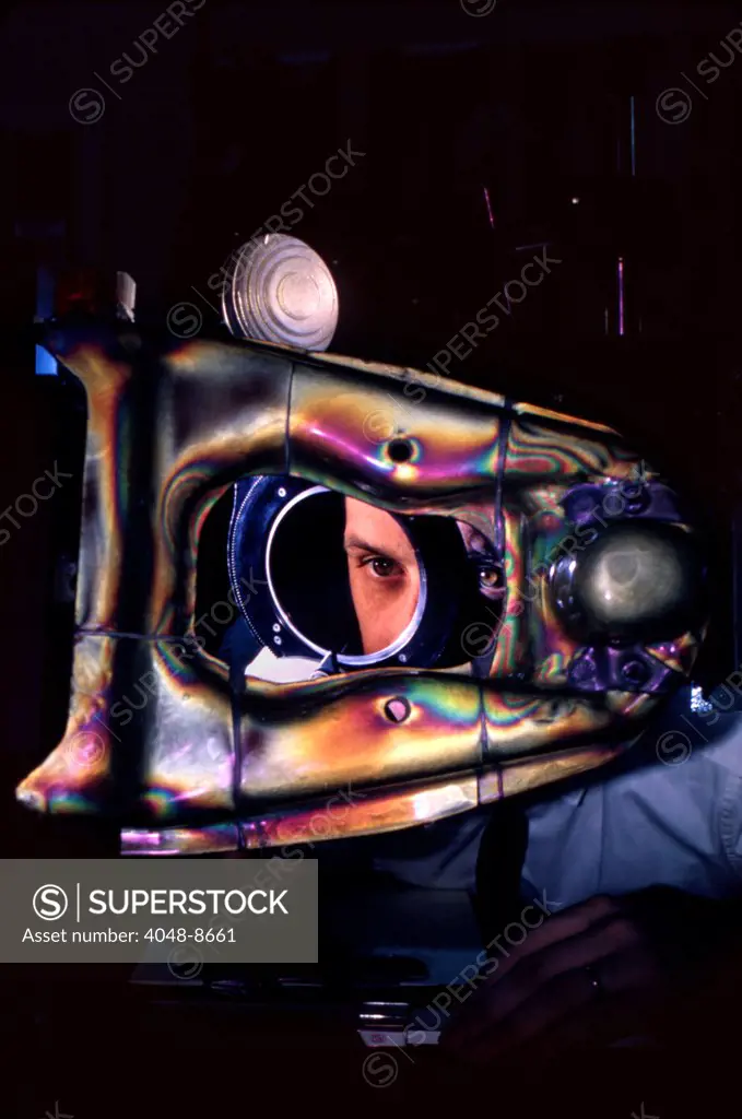 Ford test engineer looks at automobile part under polarized light to see where greatest stress occurs. Ford Motor Company, Dearborn Michigan, 1966. Photo: John G. Zimmerman Archive/Courtesy Everett Collection