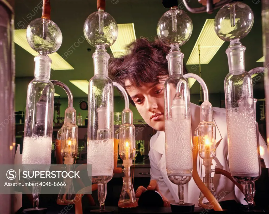 Janet Mackie, one of few female engineers in the automotive industry, measures the sulfur content of a high-octane fuel. Burned in high-compression engines, such fuels raise gas mileage without sacrificing horsepower. Ford Motor Company, Dearborn Michigan, 1966. Photo: John G. Zimmerman Archive/Courtesy Everett Collection