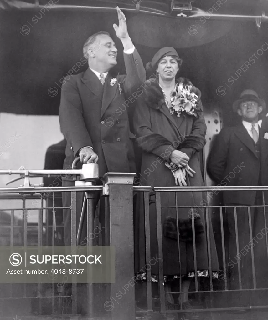 President-elect Franklin Roosevelt and wife Eleanor on the rear platform of his special train car. Following his post election meetings with President Hoover, the Roosevelts went to Warm Springs Georgia for Thanksgiving. Nov. 23, 1932.