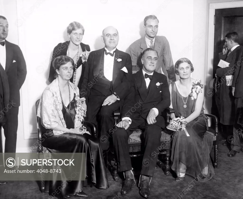 Newly re-elected New York Governor Franklin Roosevelt at Democratic headquarters at the Hotel Biltmore. Sitting L-R: Eleanor Roosevelt, Lt. Gov. Herbert Lehman, Gov. Franklin Roosevelt, and Mrs. Herbert Lehman. Standing, Mrs. Curtis Dall, daughter of Gov. Roosevelt, and son James Roosevelt. Nov. 4, 1930.