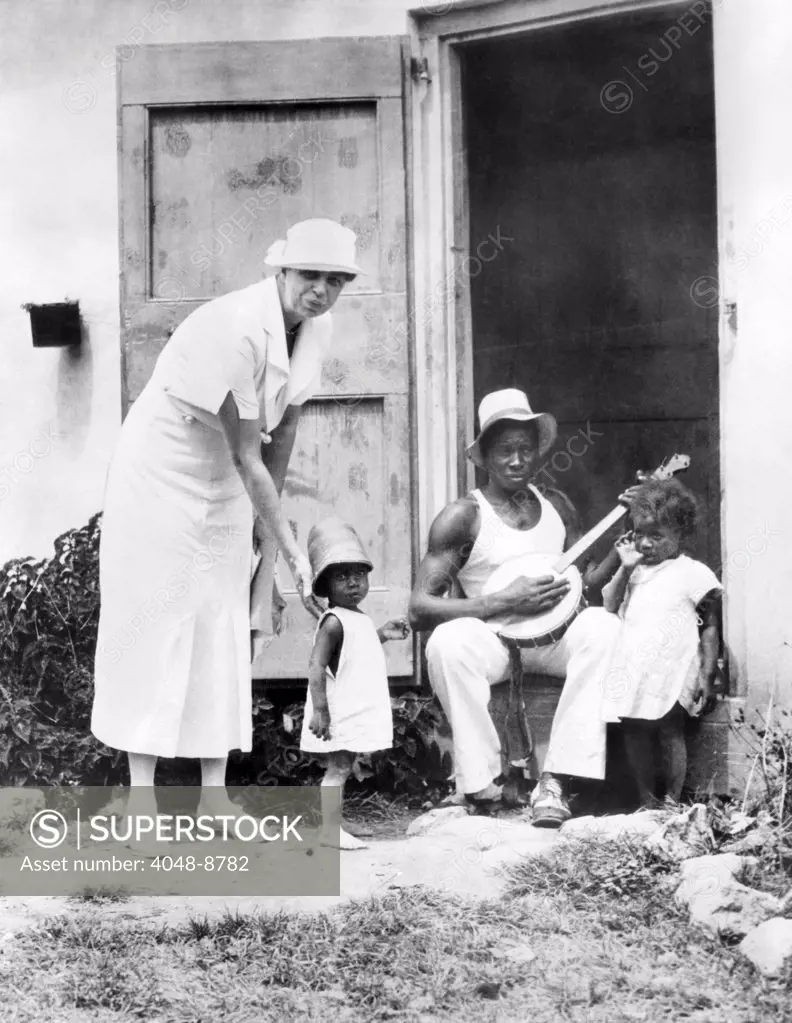 First Lady Eleanor Roosevelt chatting with the Winn family, of Christiansted, St. Croix. They live in Public Works Administration (PWA) housing. March 12, 1934.