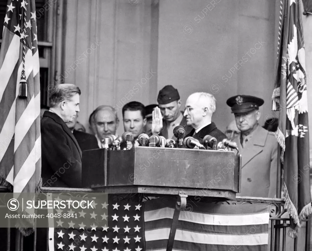 Harry Truman is sworn in a Vice President by his predecessor, Henry Wallace. On far left is outgoing VP Henry Wallace, Truman is on right with his hand raised, General Edwin Watson, President Franklin Roosevelt's special aide on far right. Jan. 20, 1945.