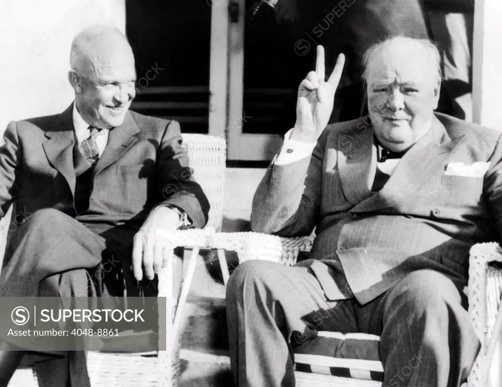 President Eisenhower watches Britain's Prime Minister Winston Churchill give his famous V-for-victory. The two were meeting along with French Prime Minister Joseph Laniel to discuss Cold War politics. Dec. 5. 1953.