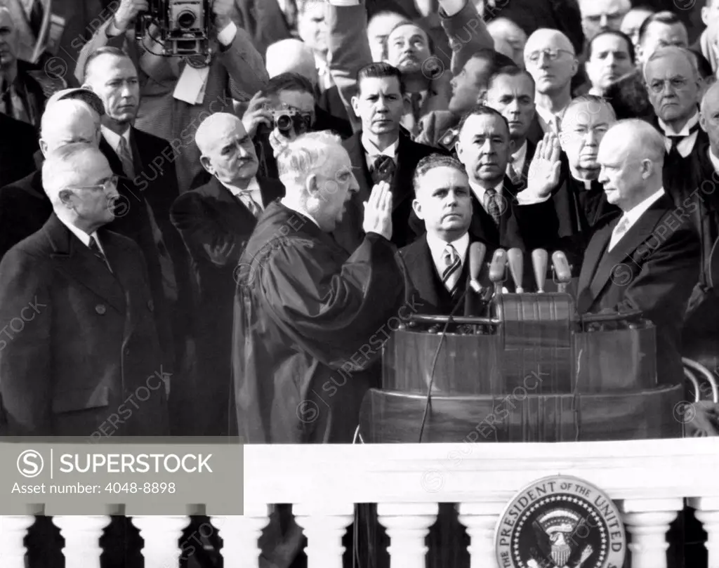 Dwight Eisenhower's first Inauguration ended 20 years of Democratic Presidential rule. L-R: President Truman, Chief Justice, Fred Vinson, Harold Willey, Supreme court clerk, holding Bible, and Eisenhower. Jan. 20, 1953.
