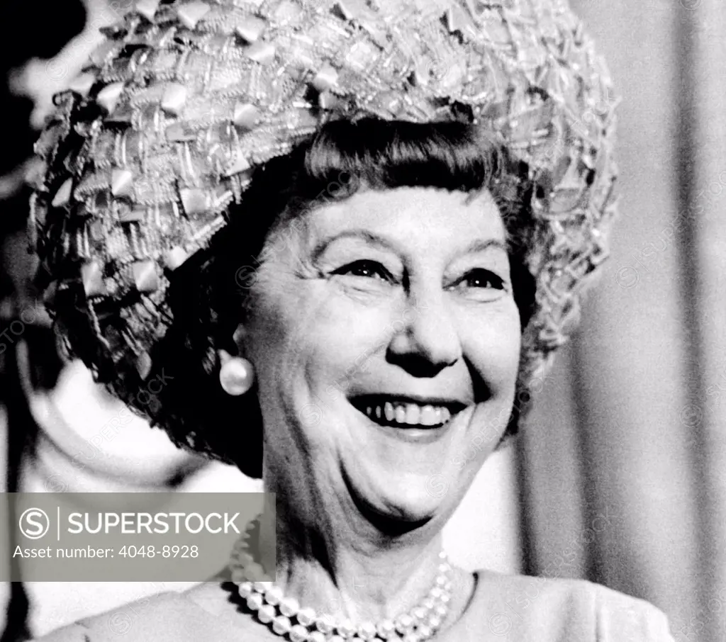 Mrs. Mamie Eisenhower, widow of President Dwight Eisenhower, smiles during a ceremony where President Nixon presented her with the first strike of the Eisenhower Silver Dollar. July 27, 1971.