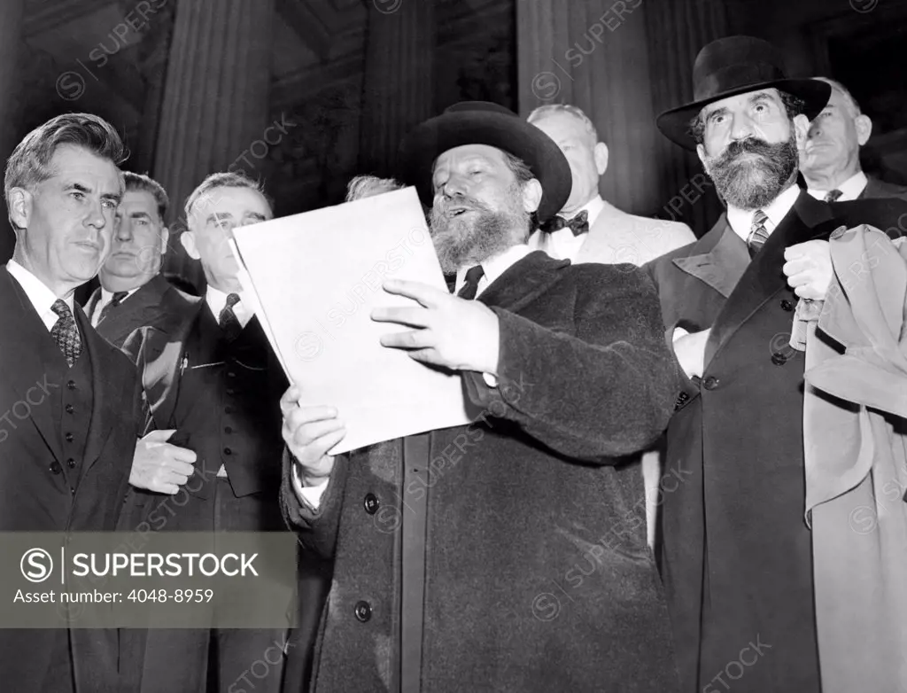 Rabbi Eliezer Silver reads a petition challenging the US to assume the role of David and deliver European Jews from extermination by modern Philistines. Silver and 300 Orthodox Rabbis presented the petition to Vice President Henry Wallace. Oct. 10. 1943.