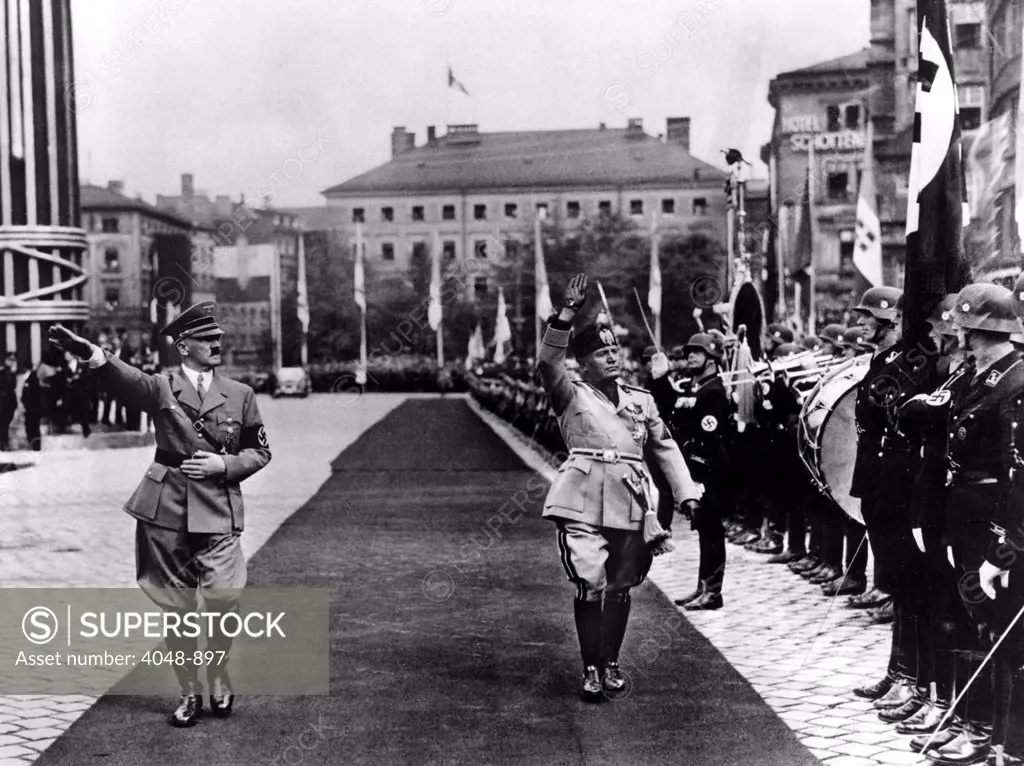 HITLER and Mussolini inspect a guard of honor in Munich, Germany 1937.