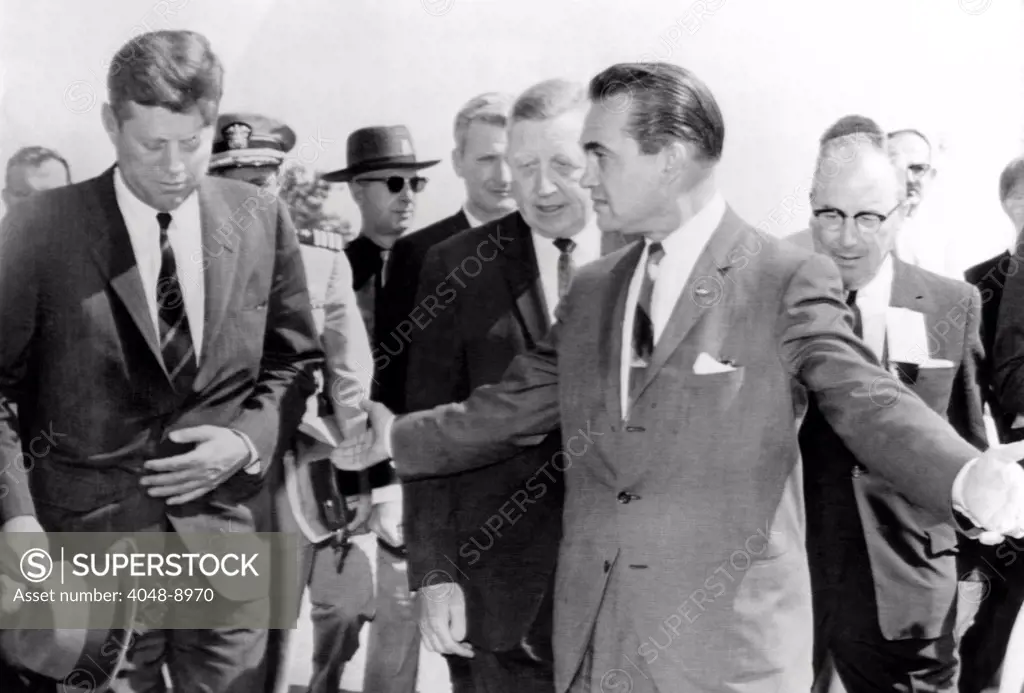 George Wallace stepping aside as President John Kennedy walks to the speakers platform at Muscle Shoals, Alabama. JFK keeps his head down, avoiding eye contact or communication with the segregationist governor. May 18, 1963.