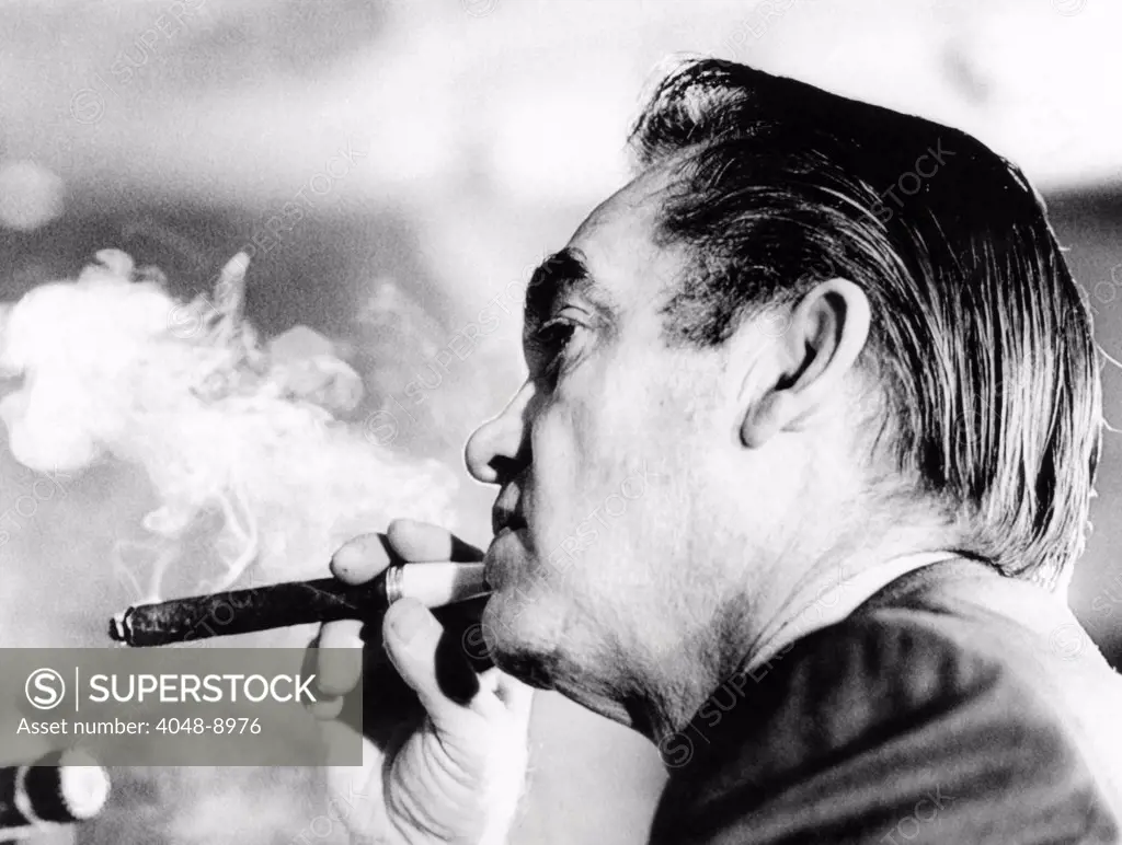 Alabama Gov. George Wallace puffs on a cigar. He was at the National Governors' Conference listening to a speech by Vice President Spiro Agnew. Feb. 23, 1972.