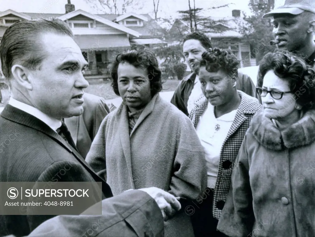 Alabama Gov. George Wallace talks to residents of an African American neighborhood that was bombed. In the 1960's, Birmingham was called, 'Bombingham', because of the frequency of white racist terrorism against integrationists. April 1, 1965.