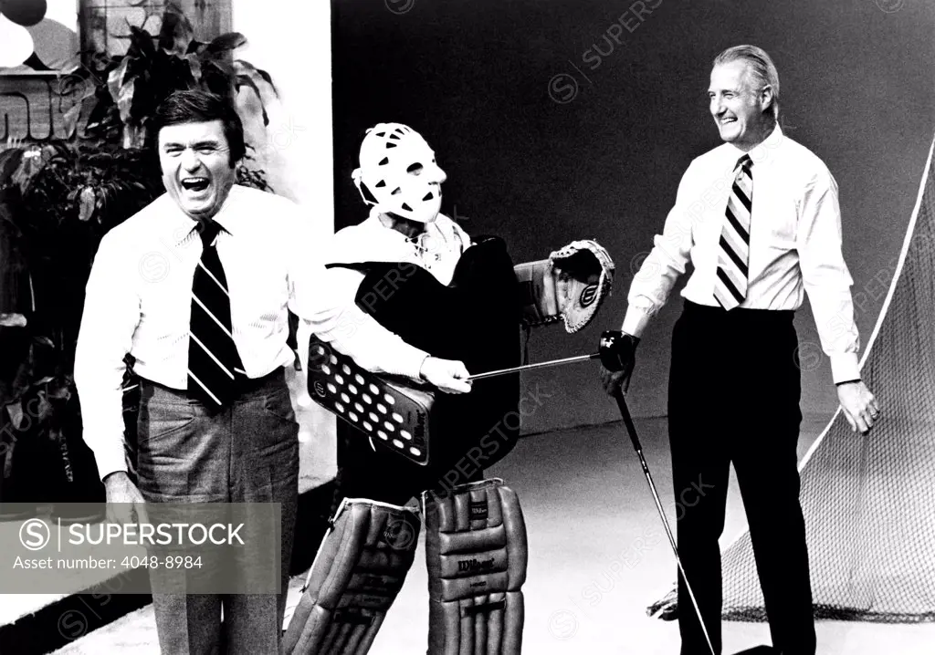 Former Vice President Spiro Agnew appeared on the 'The Mike Douglas Show' to promote his novel, 'The Canfield Decision.' Actor Jamie Farr of the M*A*S*H series, showed up for golf caddie duty clad as a hockey goalie in reference to Agnew's golf shots hitting bystanders. May 31, 1976.