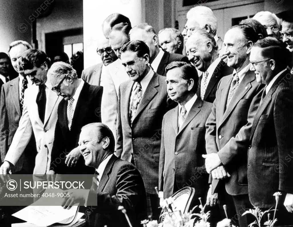 President Gerald Ford prepares signing the Employee Retirement Income Security Act of 1974. At the ceremony are: Barry Goldwater(2nd from left), Speaker of the House Carl Albert and Senate Leader, Mike Mansfield, stand behind the President. Sept. 2, 1974.