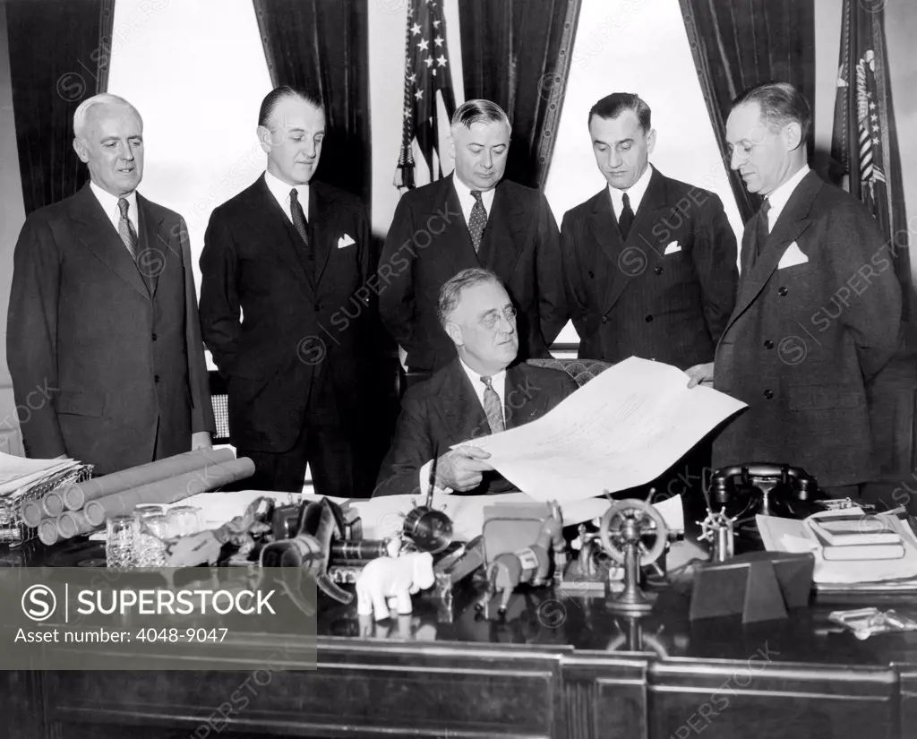 President Franklin Roosevelt commissions the Federal Reserve Board. Standing L-R: Joseph Broderick, Ronald Ransom, John McKee, M.S. Szynczak, and Board Chairman, Marriner Eccles. Feb. 3, 1936.
