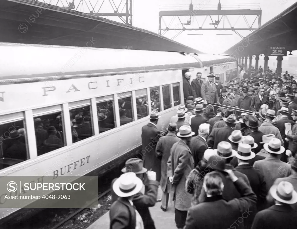 A crowd watches President Franklin Roosevelt, during his inspection of the new Union Pacific Streamliners. The new M-10000 was a prototype for first streamlined internal-combustion passenger train. Popularly known as 'The Streamliner,' it was named 'City of Salina, and was in service from 1935 to 1941. Feb. 19, 1934.