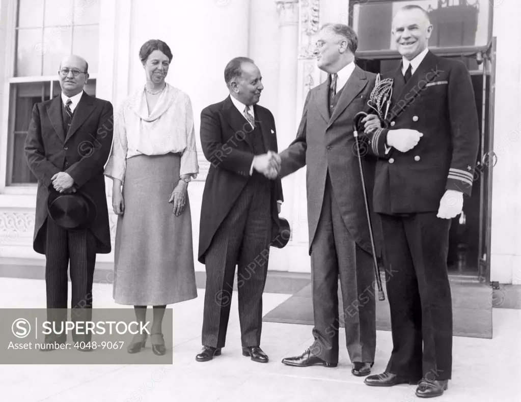 President Franklin and Eleanor Roosevelt welcome the Mexican Minister of Finance (center), Alberto Pani, to discuss world economic problems. L-R: Don Fernando Gonzales Roa, Mexican Ambassador the US, First Lady Eleanor Roosevelt, Alberto Pani, FDR, and Lt. Commander Powell, White House Naval Aide. May 11, 1933.