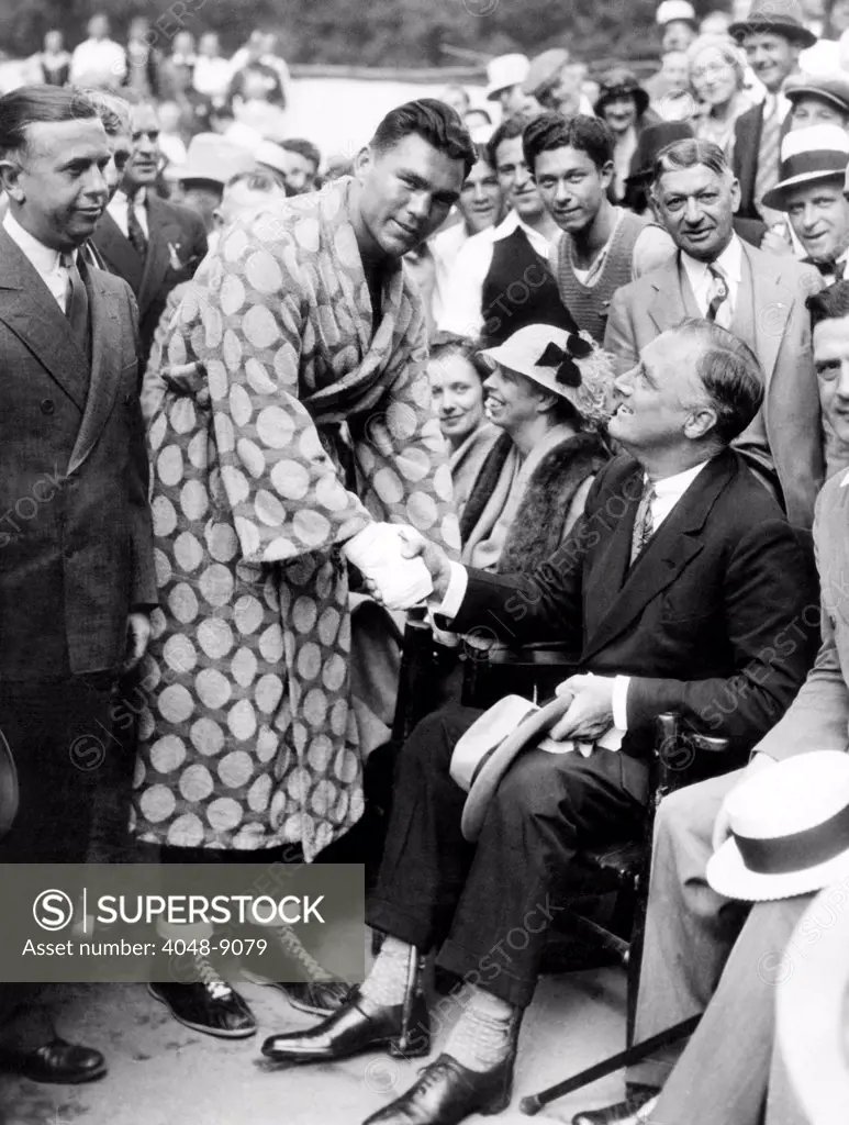 Governor Franklin D. Roosevelt shaking hands with boxer, Max Schemeling. FDR visited his training camp at Kingston, NY, where the German Heavyweight was preparing for his June 22, 1932 fight with Jack Sharkey.