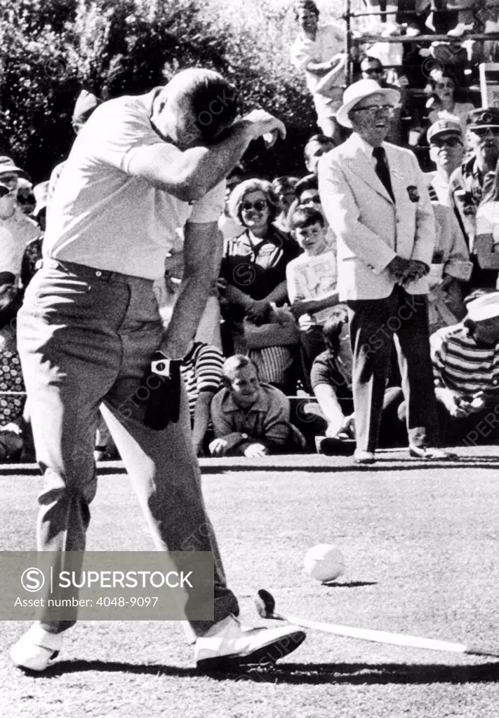 Vice President Spiro Agnew hides his face in mock shame after, once again, he hit a spectator while golfing. He was golfing at the Bob Hope Desert Classic in Palms Spring, California. Feb.13, 1971.