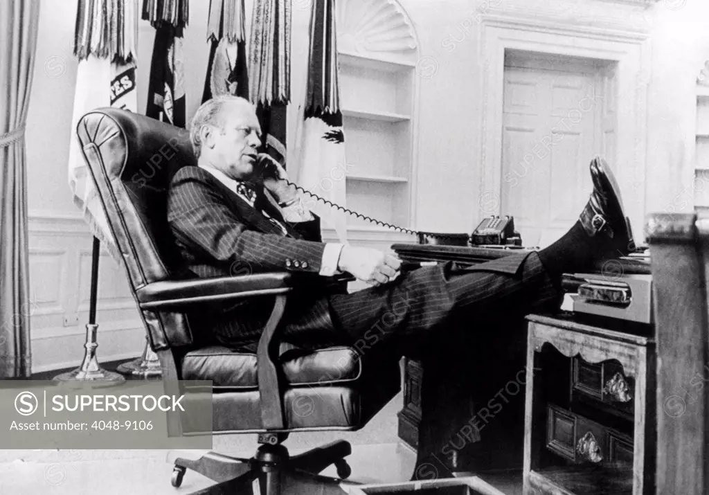 President Gerald Ford's first week in office. Ford talks on the telephone in the Oval Office in the White House. Aug. 18, 1974.
