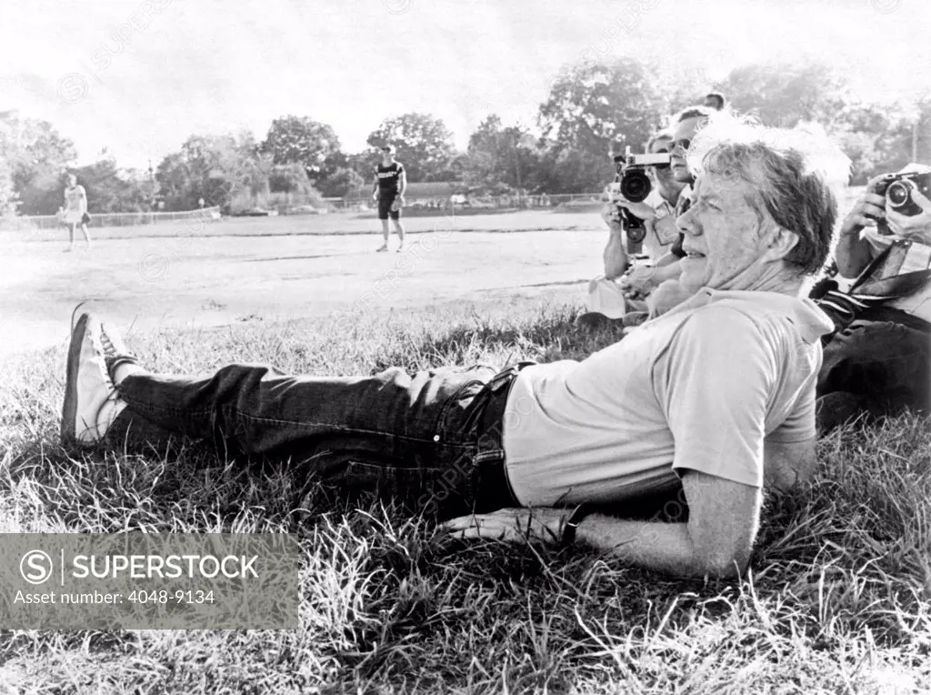 President Jimmy Carter relaxing during a softball game in Plains, Georgia. The White House staff played against a White House press team. The staff lost. Sept. 19, 1977.