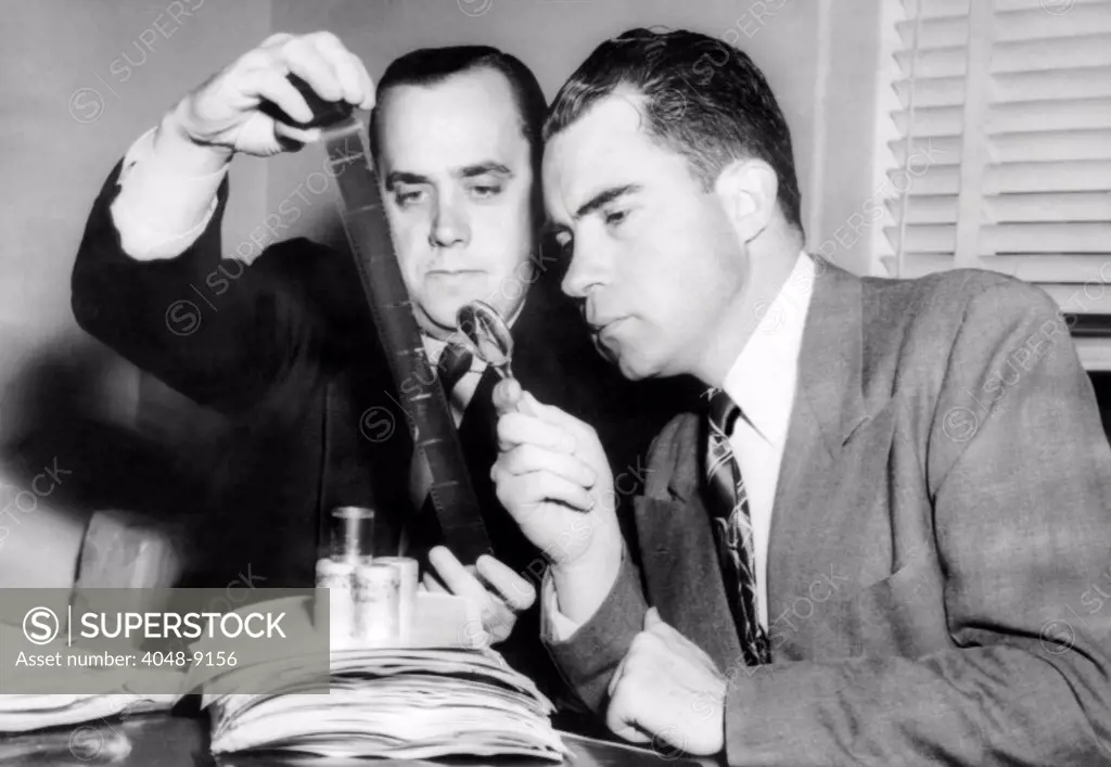 Rep. Richard Nixon and Robert Stripling (HUAC investigator) examining microfilm of the 'Pumpkin papers.The film copied were 65 pages of retyped secret State Department documents, and four pages in Alger Hiss's own handwriting of State Department cables. Dec. 6, 1948.
