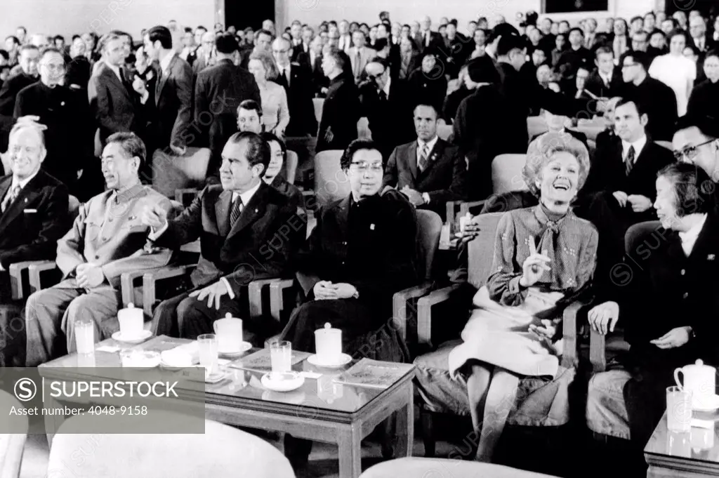 Patricia Nixon laughs as she talks with Madame Chou En-lai at the Great Hall of the People. L-R: William Rogers, Secy State, Premier Chou En-lai, President Nixon, Mme. Chiang Ch'ing, wife Chairman Mao Tse-tung, Mrs. Nixon, and Mme Chou. In the second row are H.R. Haldeman and Ron Ziegler, Press Secy. Beijing, China. Feb. 22, 1972.