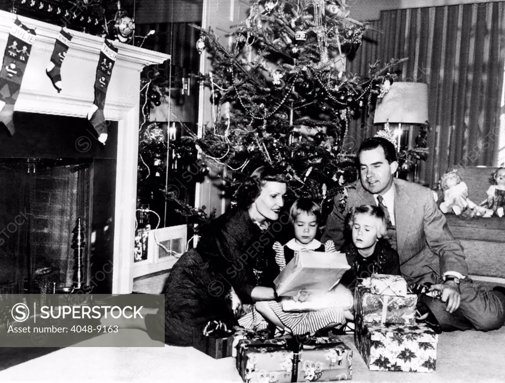 Christmas with the Vice President's family. L-R: Patrician Nixon, Checkers, the cocker spaniel, Julie, age 5, Tricia, age 7, and Richard Nixon. Dec. 24, 1953.
