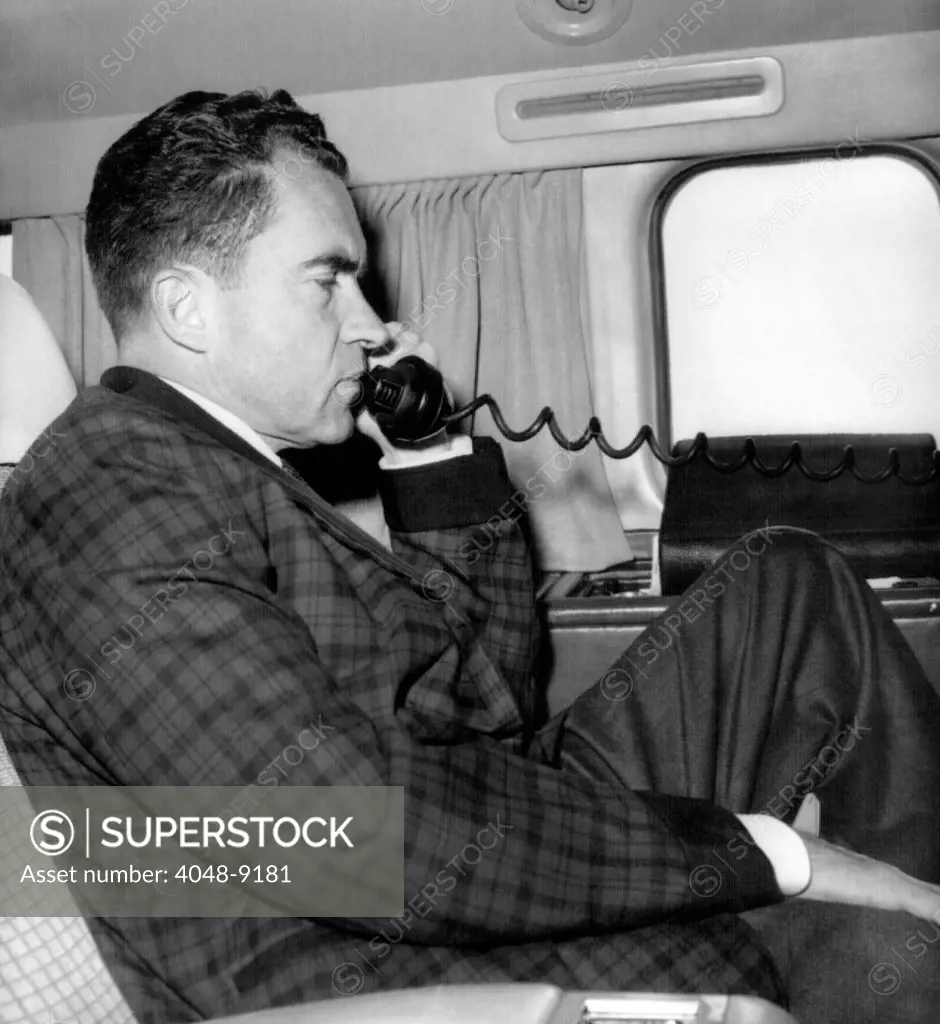 Vice President Richard Nixon uses his plane's radiotelephone while enroute from Quito, Ecuador to Bogota, Columbia. May 1, 1958.