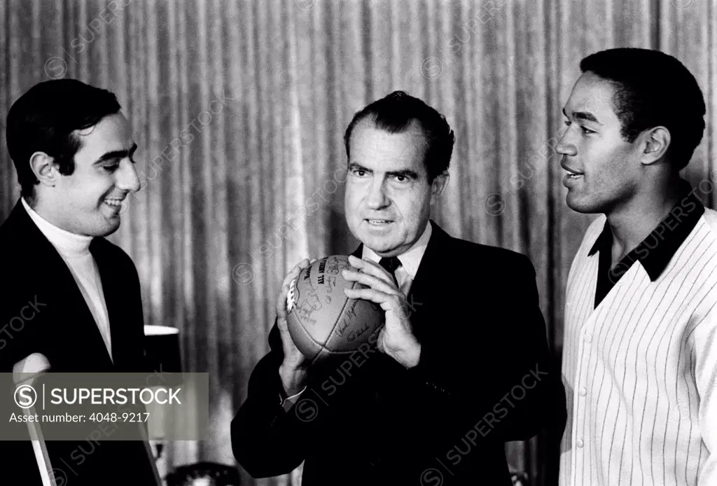 President-elect Richard Nixon was visited by All-Americans. L-R: Notre Dame quarterback Terry Hanratty, Nixon, USC running back O.J. Simpson. Dec. 2, 1968.
