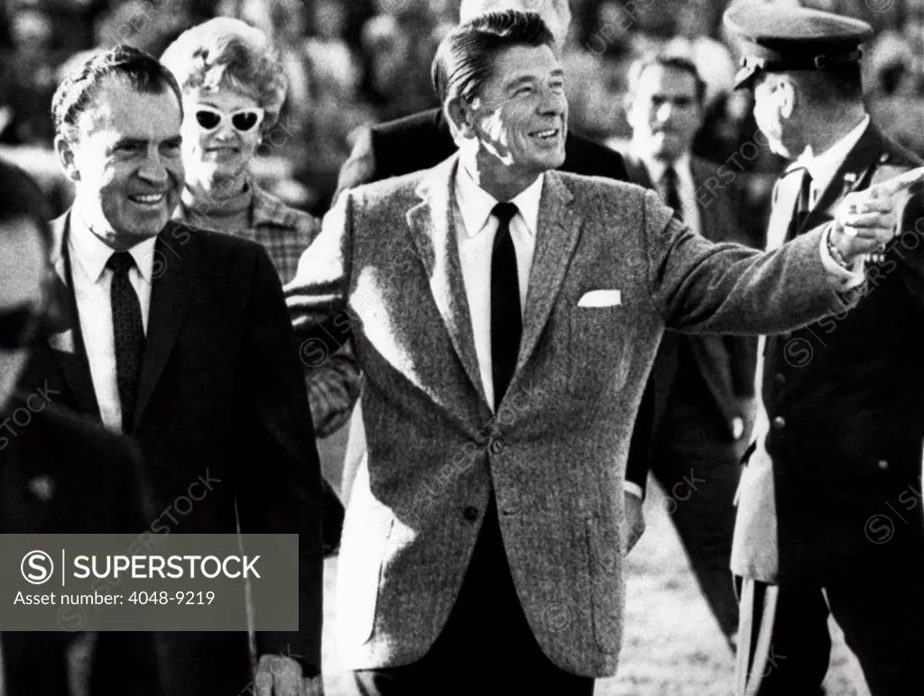Calif. Governor Ronald Reagan escorts President-elect Richard Nixon across the field at half time of the Rose Bowl game. After watching the first half on the Ohio State side, they crossed over to USC's for the end of the game. Jan. 1, 1969.