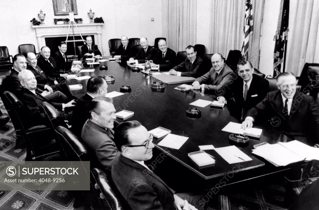 President Richard Nixon holds first formal meeting of his cabinet. Clockwise around the table: Robert Mayo, Budget Director, Robert Finch, HEW, Walter Hinckle, Interior, David Kennedy, Treasury, VP Spiro Agnew, John Mitchell, Atty. Gen., Maurice Stans, Commerce, John Volpe, Transport, Charles Yost, UN Amb., George Shultz, Labor, Winton Blount, Post master, William Rogers, State, Pres. Nixon, Melvin Laird, Defense, Clifford Hardin, Agriculture, George Romney, HUD. Jan 22, 1969.