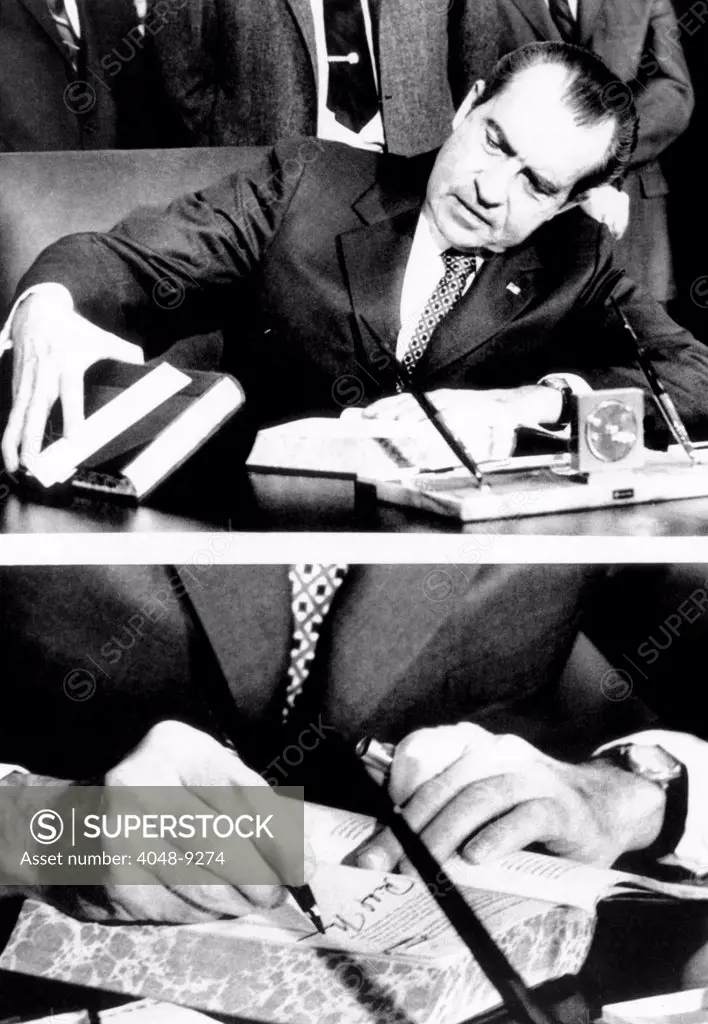 President Richard Nixon signing the budget for fiscal 1972 which he is sending to Congress.