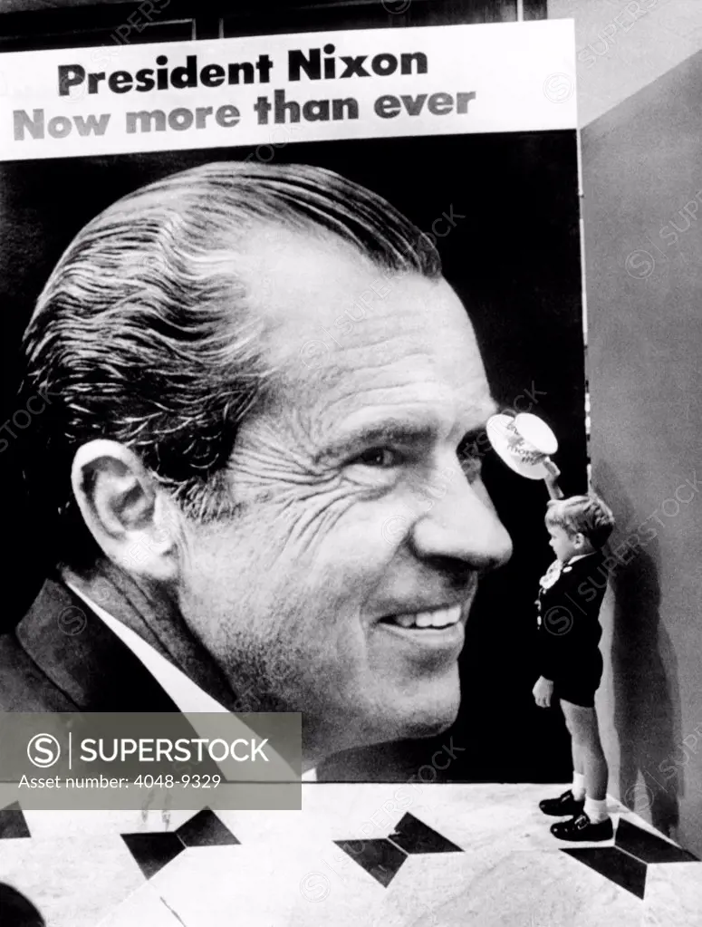 A four-year-old boy, tips his hat to a huge poster of President Nixon at the Fountainbleau Hotel. Above the image reads, President Nixon, Now more than ever. August 18, 1972.