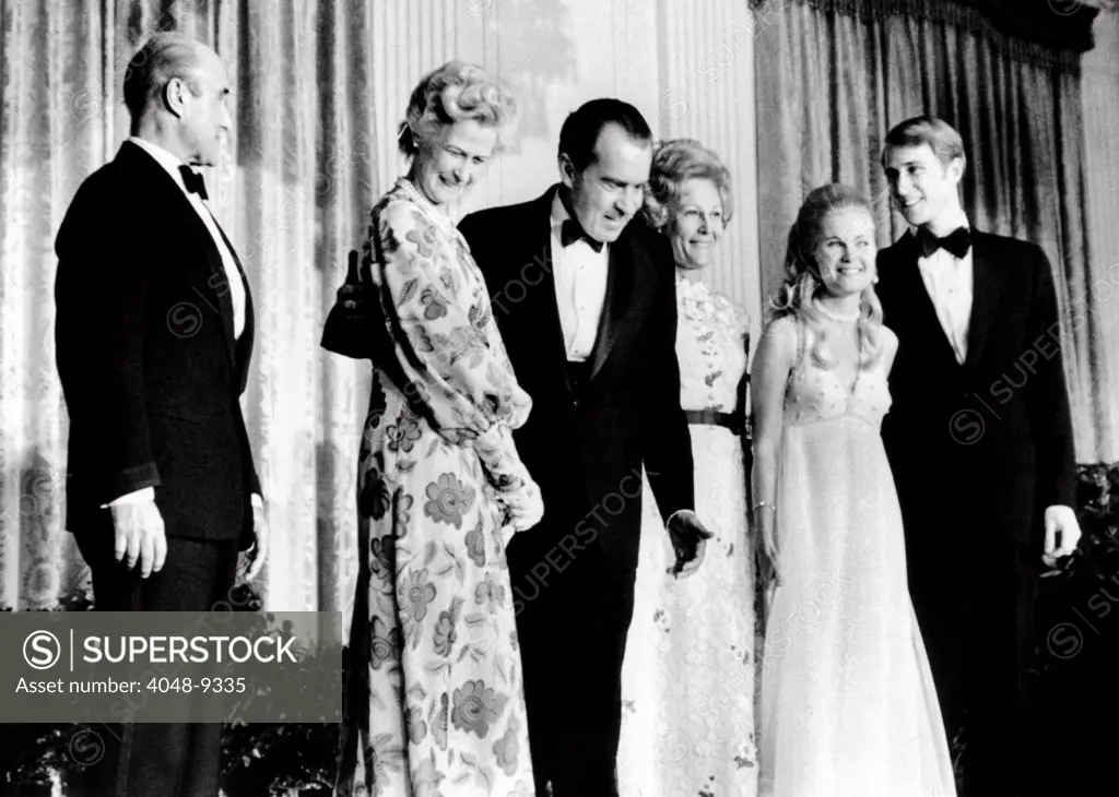 Tricia Nixon's engagement to Edward Cox is announced. At the White House party, L-R: Col. And Mrs. Howard Ellis Cox, parents of the groom-to-be, Pres. Nixon and the First Lady, and Tricia and Edward. March 16, 1971.