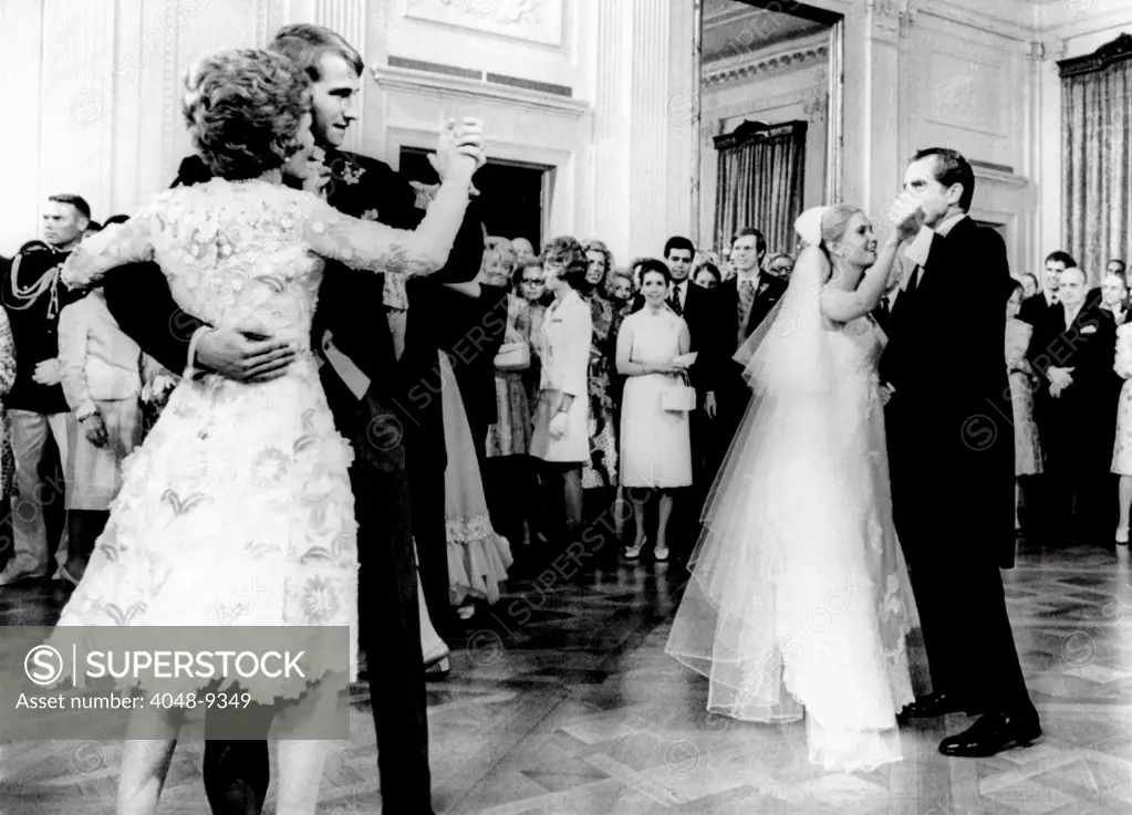Nixon-Cox White House Wedding Reception. President Nixon dances with Tricia and the First Lady with the groom, Edward Cox. Four hundred guests attended the reception in the East Room. June 12, 1971.