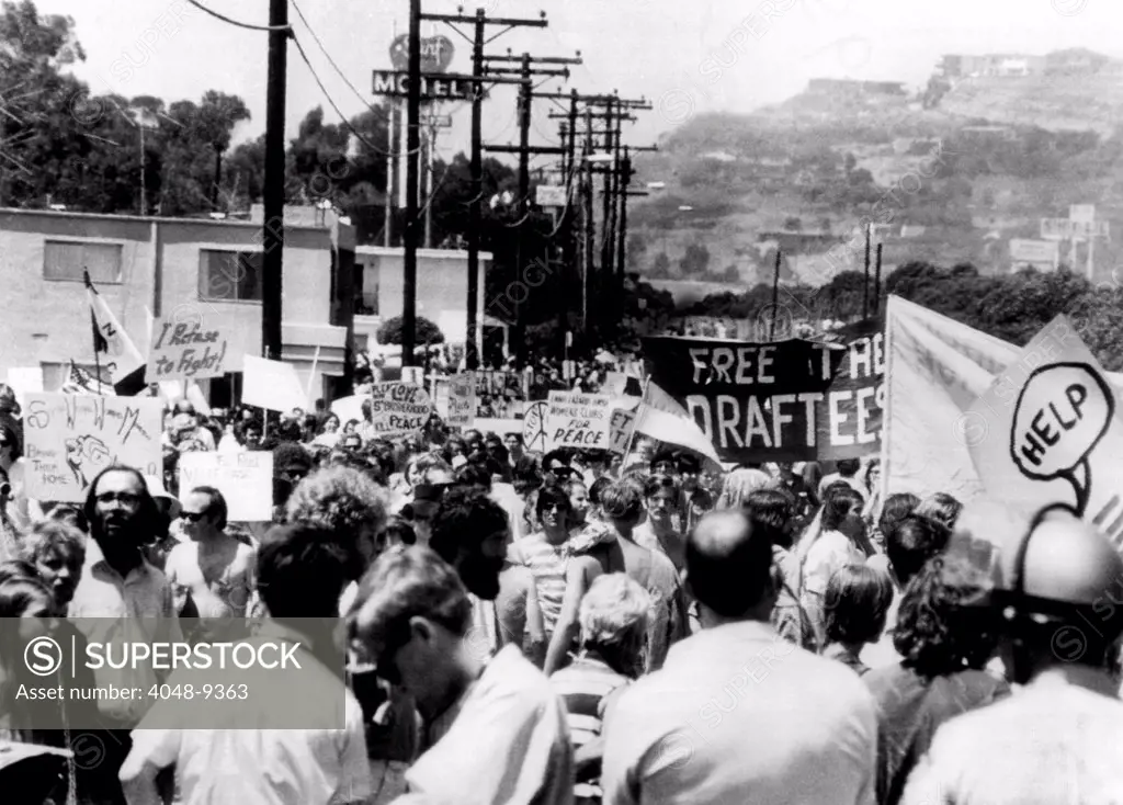 Anti-Vietnam War protest near President Richard Nixon's San Clemente home. Several thousand demonstrators protest along a street leading to the gate of Nixon's California beach front home. Signs read, 'I Refuse to Fight', and 'Free the Draftees'.  March 17, 1969.
