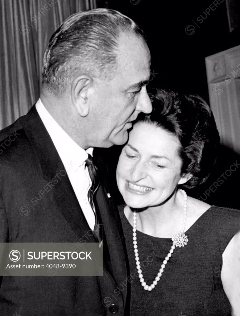 President Lyndon Johnson kisses his wife Lady Bird as they greet guests at the White House. He was hosting a dinner of the Business Council. Jan. 7, 1964.