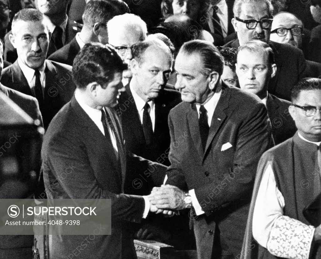 President Lyndon Johnson expresses his condolence to Senator Edward Kennedy. They were at the Requiem Mass for Senator Robert Kennedy in St. Patricks Cathedral. Also depicted: Between Kennedy and LBJ, Secret Service agent Rufus Youngblood, in upper right, is Justice Thurgood Marshall. June 8, 1968.