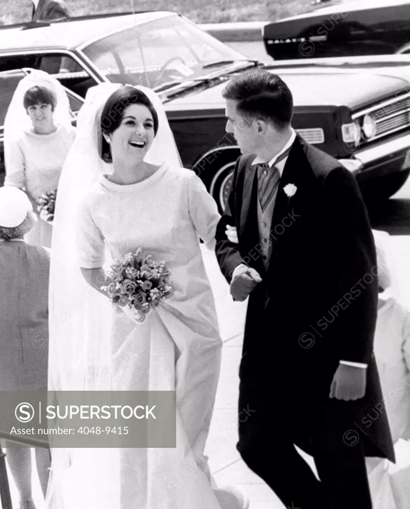 Lynda Bird Johnson, maid of honor atr her sister, Luci's wedding to Patrick Nugent. She is escorted up the steps of the National Shrine of the Immaculate Conception here by Capt. Michael Phenner, of Neenah, Wisconsin. August 6, 1966.