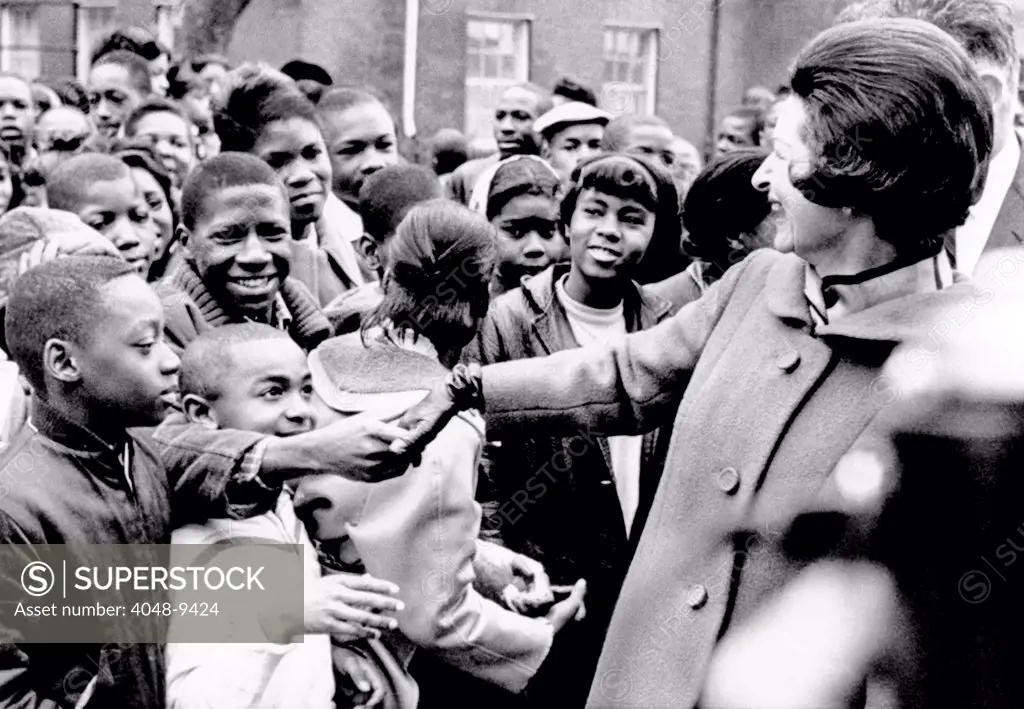 Lady Bird Johnson greets African American students in Washington, DC. She visited the school complex for over 3,000 students to dedicate the new landscaping. It was her first major 'Beautification' project in Washington, DC. Dec. 6, 1965.
