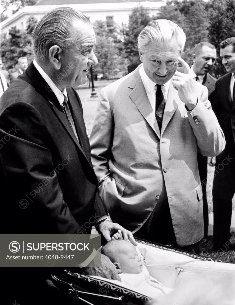 President Lyndon Johnson gives German Chancellor Kurt Georg Kiesinger a tour of the White House grounds. It includes a visit with Johnson's two month old grandson, Patrick Lyndon Nugent. Aug. 27, 1967.