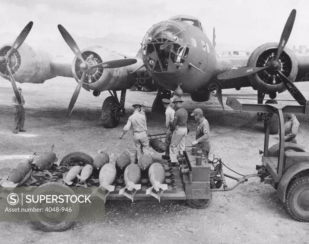 An ordnance crew loading 300 pound bombs into a U.S. Air Force bomber, Hawaii, 1942.