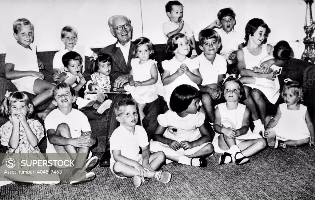 Patriarch Joseph P. Kennedy with his 17 grandchildren on his birthday, Sept. 6, 1961. Front row L-R: Sydney Lawford, Robert Kennedy Jr., Michael Kennedy, Maria Shriver, Courtney Kennedy, and Mary Kennedy. Middle row: Timothy Shriver, Victoria Lawford, Karan Kennedy, Caroline Kennedy, Robert Shriver, and Kathleen Kennedy holding John F. Kennedy Jr. Flanking Grandpa are : Joseph Kennedy, David Kennedy, Stephen Smith Jr., and Christopher Lawford.