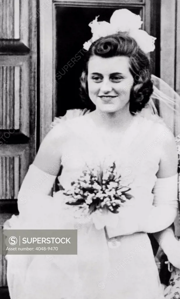 Kathleen Kennedy, in formal gown and carrying bouquet for her presentation at Buckingham Palace. May 11, 1938.