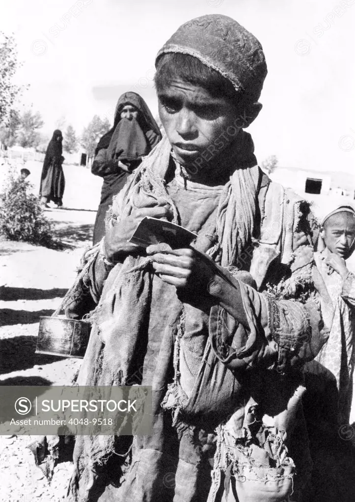 Afghan youngster in a UNICEF feeding line in Chakcharan, Ghor Province. A famine has followed two years of unprecedented drought. Jan 17, 1972.