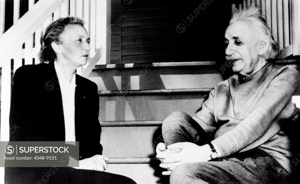 Madame Joliot-Curie and Albert Einstein. The two Nobel Prize winning physicists talk on the steps of Einstein's home in Princeton. March 1948.