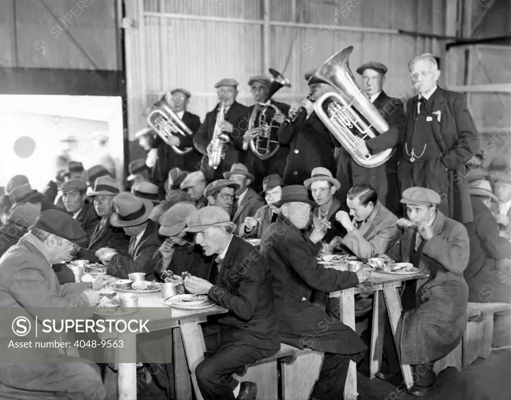 Municipal Lodging House Thanksgiving dinner. The hungry and destitute of New York City eat their free thanksgiving dinner accompanied by a brass band. Nov. 28, 1932.