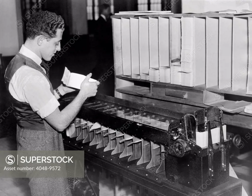 Information technology installed in the Social Security Department. A worker at of the automatic card sorters as it was being operated. Nov. 27, 1936.